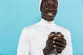 Image of african american guy smiling and holding takeway coffee cup Royalty Free Stock Photo