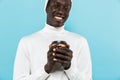 Image of african american guy smiling and holding takeway coffee cup Royalty Free Stock Photo