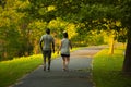 Image of an African American man and a caucasian woman walking on a hiking trail