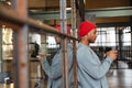 Image of african american man holding cellphone while working in office Royalty Free Stock Photo