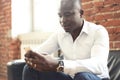 Image of african american professional businessman in business formal attire on his mobile cell smartphone. Royalty Free Stock Photo