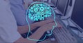 Image of ai brain with cogs over diverse people using computers Royalty Free Stock Photo