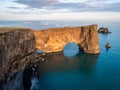 Amazing black arch of lava standing in the sea. Location cape Dyrholaey, Iceland