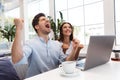 Loving couple sitting in cafe using laptop computer Royalty Free Stock Photo