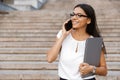 Beautiful business woman walking outdoors talking by mobile phone Royalty Free Stock Photo