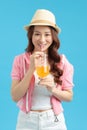 Image of amazing pretty woman isolated over blue background drinking soda