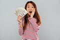 Amazing shocked young asian lady holding money. Royalty Free Stock Photo