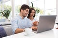 Loving couple sitting in cafe using laptop computer Royalty Free Stock Photo