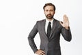 Image of angry boss, raising hand objection gesture. Denying something, saying no and tell to stop, standing over white Royalty Free Stock Photo