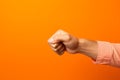 angry hand gesture on Orange background