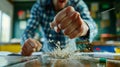 In this image, an angry man hits the table with his fist, throwing stationary items on the table off the table as a Royalty Free Stock Photo
