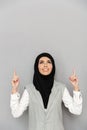 Image of arabic woman 20s in hijab smiling and looking upward wi Royalty Free Stock Photo