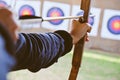 Archer holds his bow aiming at a target Royalty Free Stock Photo