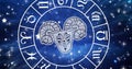 Image of aries star sign symbol in spinning horoscope wheel over glowing stars