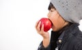 The image of an Asian girl eating a red  apple in his hand is healthy and good for a white background Royalty Free Stock Photo