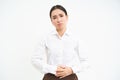 Image of asian office lady touches her belly, looks upset from discomfort in stomach, suffers period cramps at work Royalty Free Stock Photo