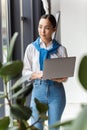 Image of asian secretary woman holding laptop computer by window Royalty Free Stock Photo