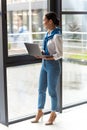 Image of asian secretary woman holding laptop computer by window Royalty Free Stock Photo