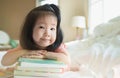 Image of Asian Toddler portrait shot while her proud and talking to present her book stack, Concept little bookworms enjoy Royalty Free Stock Photo