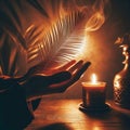 image 1:1 aspect ratio - hands held in prayer with a palm frond and a candle