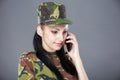 Image of attractive female soldier talking on cell phone