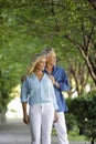 Mature couple posing under arching trees Royalty Free Stock Photo