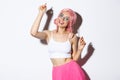 Image of attractive party girl with pink wig and bright makeup, having fun and celebrating holiday, dancing happy over