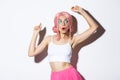 Image of attractive party girl with pink wig and bright makeup, having fun and celebrating holiday, dancing happy over