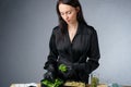 Image of attractive woman with sprouts in containers