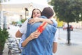 Image of attractive woman with present box giving hug to her man