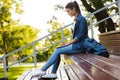 Young beautiful woman sitting outdoors using laptop computer. Royalty Free Stock Photo