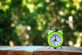 Image of autumn Time Change. Fall back concept. Dry leaves and vintage alarm Clock on wooden table outdoors at afternoon Royalty Free Stock Photo