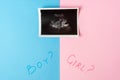 Image of baby in mother womb during ultrasound. Words BOY, GIRL and question mark on pink and blue background