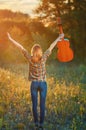 Image from the back of a happy young woman on the plaid shirt and blue jeans. Royalty Free Stock Photo