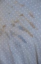 White polka dots on dull blue fabric