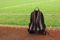 Image of backpack at the edge of football field. Soccer school concept image Royalty Free Stock Photo