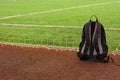 Image of backpack at the edge of football field. Soccer school concept image Royalty Free Stock Photo