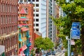 Backside of colorful Chinatown building in San Francisco with trolley down steep hill