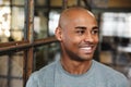 Image of bald african american man smiling and looking aside indoors Royalty Free Stock Photo