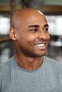 Image of bald african american man smiling and looking aside indoors Royalty Free Stock Photo