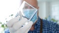 Image with a Bartender Wearing Protective Gloves and Face Mask Cleaning a Glass