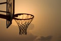 Image Basketball hoop with net silhouetted by warm light, copy space Royalty Free Stock Photo