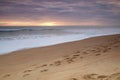 Image of a beach showing footprints in the foreground Royalty Free Stock Photo