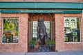 Bear statue in metal cage of gallery storefront with red brick