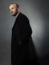 Bearded man in a black coat