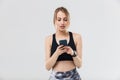 Image of beautiful blond woman 20s dressed in sportswear using smartphone during workout in gym Royalty Free Stock Photo