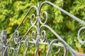 Image of a Beautiful decorative cast iron wrought fence with artistic forging. Metal guardrail close up.