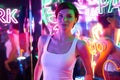 Image of a beautiful girl in an amusement park in a room with neon light. Entertainment concept