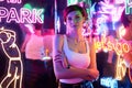 Image of a beautiful girl in an amusement park in a room with neon light. Entertainment concept