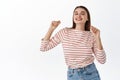 Image of beautiful girl enjoying good day, dancing and having fun, smiling with happy positive expression, posing Royalty Free Stock Photo